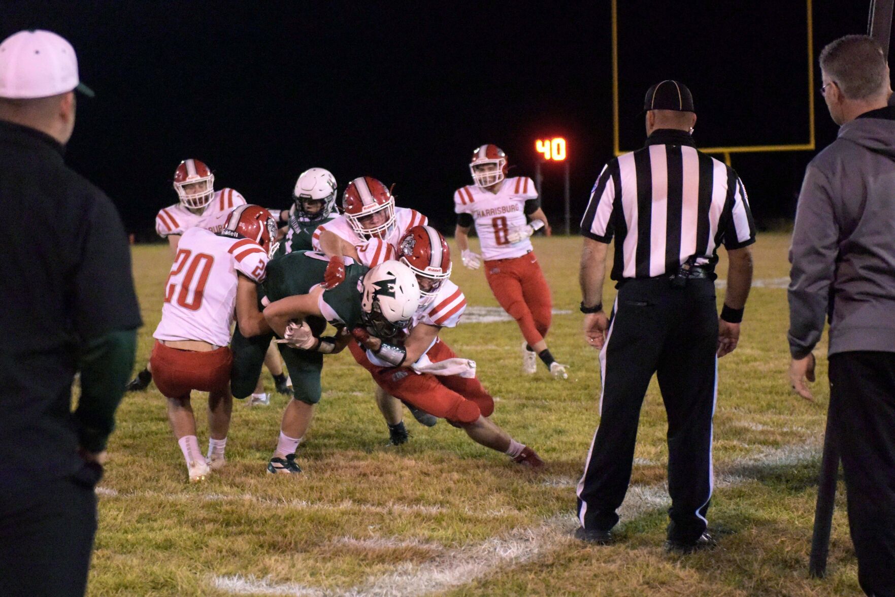 The Harrisburg High School defense swarms Westran wide receiver Garrett Adler